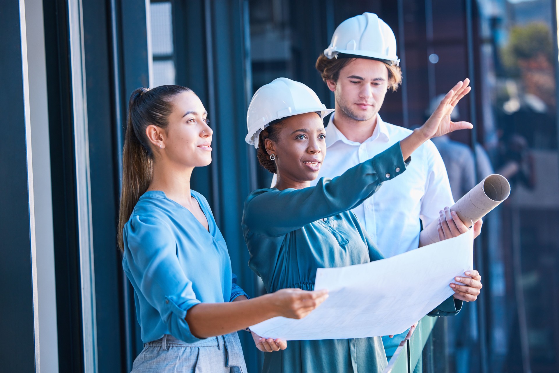 Building construction management team with an architect and engineering blueprint. Teamwork development collaboration of industrial engineer group planning a architecture renovation project